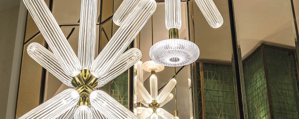 A 15-foot starburst chandelier by Czech crystal manufacturer Lasvit is inspired by Yabu Pushelberg's Cipher collection.